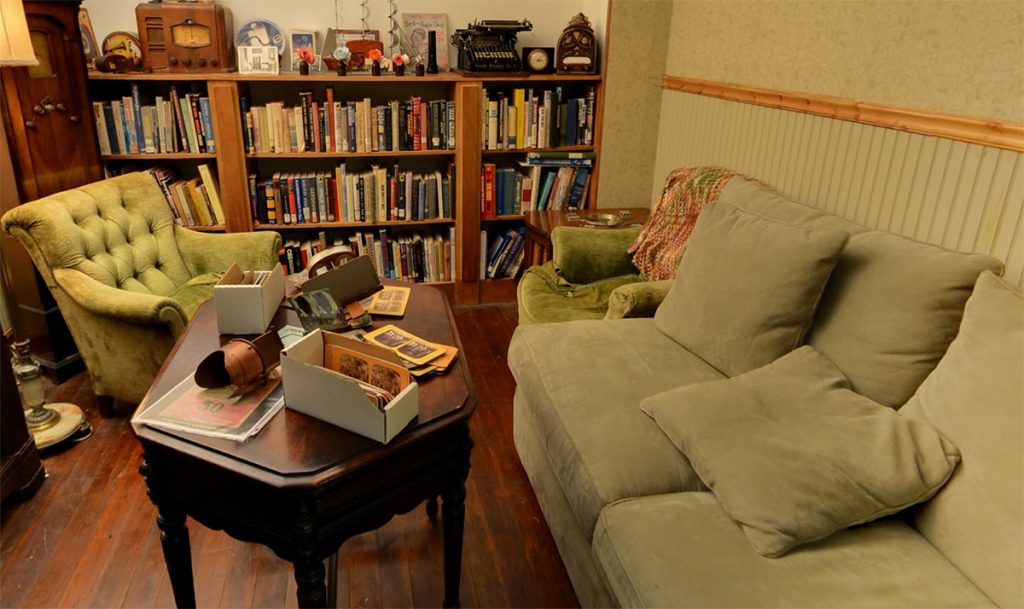 1930's living room with sofa period-accurate electrical and other devices for entertainment.